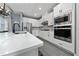 Well-equipped kitchen with white cabinets, quartz countertops, and stainless steel appliances at 1335 Greenfield Loop, Kissimmee, FL 34747