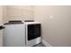 Laundry room featuring white washer and dryer, vinyl flooring, and wire shelving at 1335 Greenfield Loop, Kissimmee, FL 34747