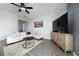 Comfortable living room featuring modern decor and a large TV, perfect for relaxation and entertainment at 1335 Greenfield Loop, Kissimmee, FL 34747