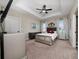 Spacious main bedroom featuring ceiling fan, tray ceiling, and decorative lighting at 1335 Greenfield Loop, Kissimmee, FL 34747
