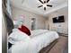Cozy main bedroom showcasing decorative pillows, neutral decor, and a ceiling fan at 1335 Greenfield Loop, Kissimmee, FL 34747