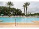 Enjoy the community pool with plenty of lounge chairs and shade under palm trees at 1335 Greenfield Loop, Kissimmee, FL 34747