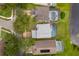 Aerial view of neighborhood homes with screened-in pools, lush lawns, and a tranquil pond at 13525 Mallard Cove Blvd, Orlando, FL 32837