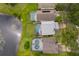 A high angle showcases a home with a screened pool, blending seamlessly with the adjacent pond at 13525 Mallard Cove Blvd, Orlando, FL 32837