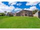 Spacious backyard featuring a screened-in pool and a grassy area perfect for outdoor activities at 13525 Mallard Cove Blvd, Orlando, FL 32837