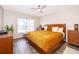 Cozy bedroom with wood flooring, and a large bed at 13525 Mallard Cove Blvd, Orlando, FL 32837