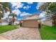 Inviting two-story home with lush lawn, mature landscaping, and a spacious two-car garage at 13525 Mallard Cove Blvd, Orlando, FL 32837