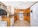 Kitchen featuring granite countertops, tile backsplash, stainless steel appliances and tile flooring at 13525 Mallard Cove Blvd, Orlando, FL 32837