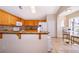 Kitchen featuring granite countertops, tile backsplash, stainless steel appliances and a breakfast nook at 13525 Mallard Cove Blvd, Orlando, FL 32837