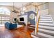 Open-concept living room features hardwood floors, a staircase, and is adjacent to the pool at 13525 Mallard Cove Blvd, Orlando, FL 32837