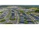 Expansive aerial view of the community, surrounded by lush greenery and featuring coordinated home designs at 1719 Daystar Dr, Haines City, FL 33844