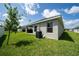 Well-maintained backyard with an outdoor kitchen, covered patio, and lush green grass at 1719 Daystar Dr, Haines City, FL 33844