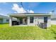 Expansive backyard featuring a covered patio with an outdoor kitchen, ideal for relaxation and gatherings at 1719 Daystar Dr, Haines City, FL 33844