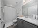 Bathroom with a shower/tub combo, gray cabinets, and a sleek countertop at 1719 Daystar Dr, Haines City, FL 33844