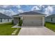 Charming single-story home featuring a spacious two-car garage and a well-manicured lawn at 1719 Daystar Dr, Haines City, FL 33844