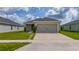 Charming single-story home featuring a spacious two-car garage and a well-manicured lawn at 1719 Daystar Dr, Haines City, FL 33844