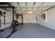 Large garage with home gym equipment, offering plenty of room for fitness activities and storage at 1719 Daystar Dr, Haines City, FL 33844