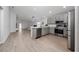 Open-concept kitchen features gray cabinets, stainless steel appliances, and easy access to the living area at 1719 Daystar Dr, Haines City, FL 33844
