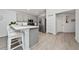 Bright kitchen with gray cabinets, stainless appliances, and a breakfast bar with seating for casual dining at 1719 Daystar Dr, Haines City, FL 33844