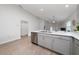 Stylish kitchen with gray cabinets, stainless steel appliances, and a seamless transition to the living space at 1719 Daystar Dr, Haines City, FL 33844