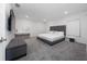 Spacious main bedroom features a gray upholstered bed frame and headboard and a gray ottoman at 1719 Daystar Dr, Haines City, FL 33844
