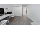 Spare room/office features a modern white desk and gray lounge furniture at 1719 Daystar Dr, Haines City, FL 33844