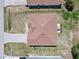 Aerial view of the property showcasing the roof, driveway, and landscaping at 1912 Manatee Ln, Poinciana, FL 34759