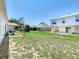 A spacious backyard featuring a patio area, green grass and a well maintained garden at 1912 Manatee Ln, Poinciana, FL 34759