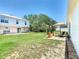 A spacious backyard featuring a patio area, green grass and a well maintained garden at 1912 Manatee Ln, Poinciana, FL 34759