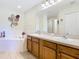 Bathroom featuring a double vanity, soaking tub, and decorative details; perfect for relaxation at 1912 Manatee Ln, Poinciana, FL 34759