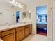 Bathroom with a double vanity and a view into the primary bedroom at 1912 Manatee Ln, Poinciana, FL 34759