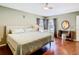 Serene bedroom featuring hardwood floors, a ceiling fan, and ample natural light through windows at 1912 Manatee Ln, Poinciana, FL 34759