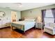 Comfortable bedroom featuring hardwood floors, a ceiling fan, and neutral walls, creating a peaceful retreat at 1912 Manatee Ln, Poinciana, FL 34759