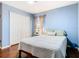 Cozy bedroom featuring hardwood floors, ceiling fan, large window, and closet at 1912 Manatee Ln, Poinciana, FL 34759