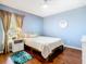 Bedroom with hardwood floors, ceiling fan, and large window, nicely decorated at 1912 Manatee Ln, Poinciana, FL 34759