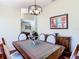 Elegant dining room featuring a classic wood table, decorative chandelier, and arched windows at 1912 Manatee Ln, Poinciana, FL 34759