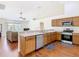 Open kitchen with stainless steel appliances, light countertops, and seamless flow to the living area at 1912 Manatee Ln, Poinciana, FL 34759
