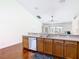 Kitchen featuring a double sink and a view into the open living and dining areas at 1912 Manatee Ln, Poinciana, FL 34759