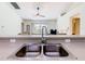 Close-up of the kitchen sink area with a view of the living room and sliding glass doors at 1912 Manatee Ln, Poinciana, FL 34759
