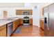Well-equipped kitchen featuring stainless steel appliances, ample counter space, and hardwood floors at 1912 Manatee Ln, Poinciana, FL 34759
