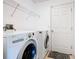 Functional laundry room with modern LG washer and dryer, plus wire shelving for extra storage at 1912 Manatee Ln, Poinciana, FL 34759