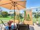 Outdoor patio with a stylish seating area featuring an umbrella and decorative plants at 1912 Manatee Ln, Poinciana, FL 34759