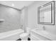 Modern bathroom featuring stylish vanity, elegant mirror, and tiled shower at 2 Dogwood Radl, Ocala, FL 34472