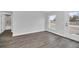 Bedroom features luxury vinyl flooring, white walls, trim, a bright window and a full bathroom at 2 Dogwood Radl, Ocala, FL 34472