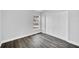 Bedroom featuring closet and gray tone walls with gray wood-look floors and natural light from window at 2 Dogwood Radl, Ocala, FL 34472
