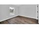 Bedroom featuring gray tone walls and gray wood-look floors and natural light from window at 2 Dogwood Radl, Ocala, FL 34472