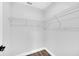 Walk in closet with metal shelving and gray tone walls and gray wood-look floors at 2 Dogwood Radl, Ocala, FL 34472
