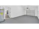 Spacious garage with neutral walls, garage door, and a water heater at 2 Dogwood Radl, Ocala, FL 34472