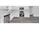 Updated kitchen features stainless steel appliances, a window view, and white cabinetry with modern finishes at 2 Dogwood Radl, Ocala, FL 34472