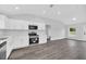 Spacious kitchen features stainless steel appliances, white cabinets, and durable gray wood-look flooring at 2 Dogwood Radl, Ocala, FL 34472